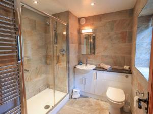 a bathroom with a shower and a toilet and a sink at Ghyll Bank House in Staveley +49 photos