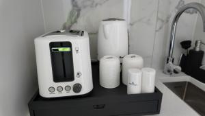 a coffee maker and some paper towels on a counter at Taupo Premium Retreat - Private Spa & Ensuite in Taupo