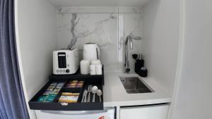 a small kitchen with a sink and a counter at Taupo Premium Retreat - Private Spa & Ensuite in Taupo