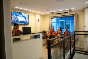 a group of people sitting in a waiting room at Favela Hostel in Rio de Janeiro