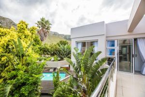 a view of the pool from the balcony of a house at Hermanus Manor in Hermanus