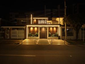 a house with lights on the front of it at night at Santa Barbara Central Suites in Bogotá