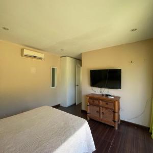 a bedroom with a bed and a flat screen tv at Rincon del Diario in Punta del Este