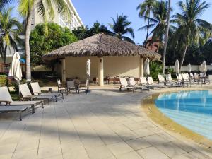 a resort with chairs and a swimming pool at IXTAPA LUXURY - BVG 405 Norte in Ixtapa