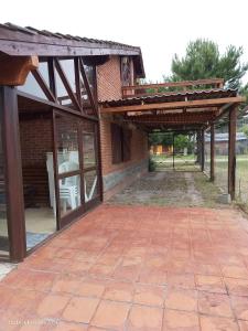 an outdoor patio with awning and a brick yard at Complejo Rancho Grande in Nueva Atlantis
