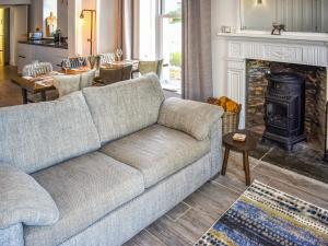 a living room with a couch and a fireplace at Cedars in Mortehoe