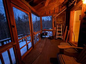 a view from the inside of a cabin with windows at Adirondack Butterfly Hillside in North Creek