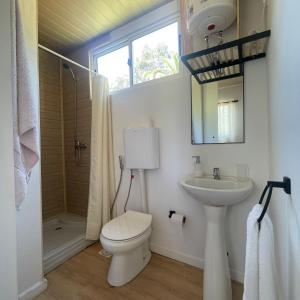 a bathroom with a toilet and a sink and a shower at Rincon del Diario in Punta del Este +68 photos