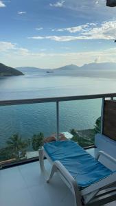 a balcony with a view of the water at Casa vista infinita in Mangaratiba