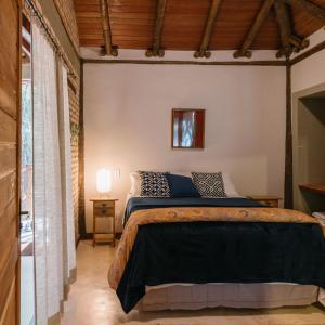 a bedroom with a large bed in a room at Chalé Tororão - São Jorge GO in Sao Jorge