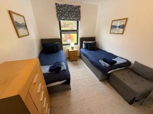 a living room with two beds and a couch at Misty Isles View in Portree