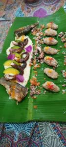 a bunch of food on a green leaf at La foca da Croa in Goiana +54 photos