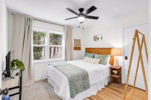 a bedroom with a bed and a ceiling fan at The Porter Chamber in Ocean Springs +163 photos
