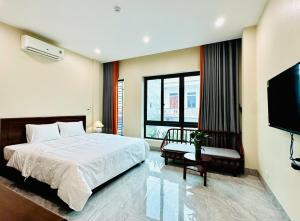 a bedroom with a bed and a flat screen tv at An's Home Ninh Binh in Ninh Binh