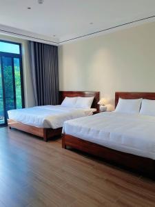 two beds in a hotel room with two beds sidx sidx sidx at An's Home Ninh Binh in Ninh Binh +48 photos