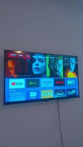 a flat screen tv sitting on top of a table at white house Bluewaterbay in Gqeberha