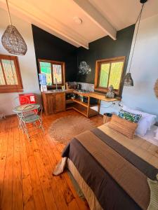 a bedroom with a bed and a desk in it at Tiny House 3 En el río in Linares