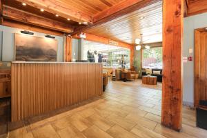 a lobby of a restaurant with a wooden wall at Bayshore Inn & Spa in Waterton Park