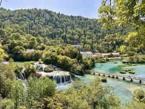a river with a bridge and a waterfall at Casa Blu in Šibenik