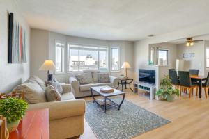 a living room with a couch and a table at Relax Poolside! Lake-View Retreat in Osage Beach in Osage Beach