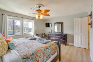 a bedroom with a bed and a dresser and a ceiling fan at Relax Poolside! Lake-View Retreat in Osage Beach in Osage Beach +24 photos