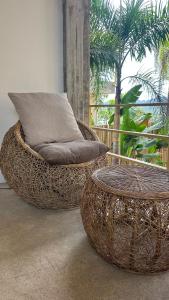 two wicker chairs and a pillow in a room at VISTA Cadlao in El Nido Airport