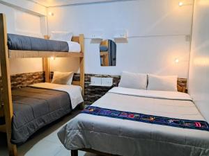 a bedroom with two bunk beds in a room at HOSTAL La RASA in Cusco