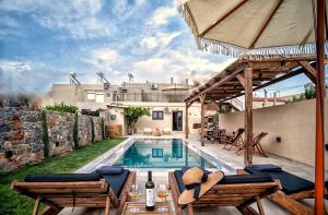 a villa with a swimming pool and a house at stone villa marianna With private pool &guest studio in Moukhtároi