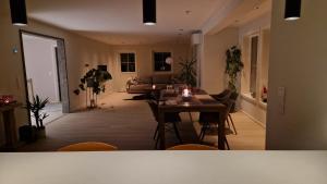 a living room with a table and a couch at Villa Modum in Skreppen