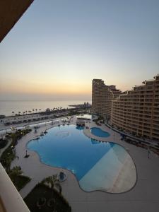 an aerial view of a resort with a pool and the ocean at Porto Sokhna Aprtment Pool View - MR in Ain Sokhna