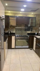 a kitchen with a stove top oven in a room at Zm apartment shehab Vib in Giza