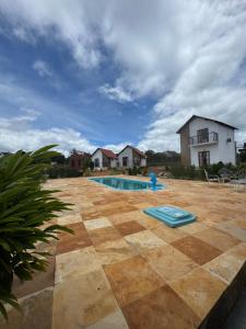 a swimming pool in the yard of a house at Chalés do Abraão in Martins