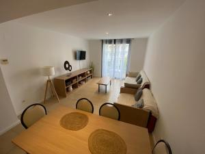 a living room with a couch and a table at Osaka Suite in Lloret de Mar