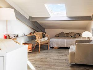 a attic bedroom with a bed and a window at Apartment Barasteguia by Interhome in Ciboure