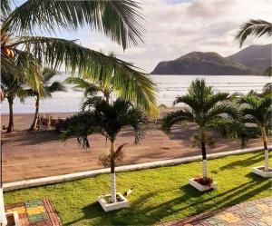 a view of a beach with palm trees and the ocean at Guanico Beach Resort in Tonosí