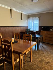 a dining room with wooden tables and chairs at Bercy in Valdivia