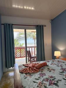 a bedroom with a bed and a view of the ocean at Guanico Beach Resort in Tonosí