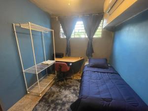 a small room with a bed and a desk and a desk at Casa Maruja CoLiving Walk to Beach in Puerto Vallarta