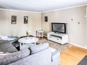 a living room with a couch and a tv at Villa Äppelgården by Interhome in Örebro
