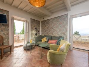 a living room with a couch and a table at Holiday Home Nobile by Interhome in Polveraia