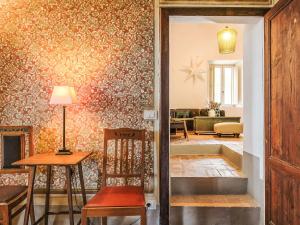 a hallway with a table and a chair in a room at Holiday Home Nobile by Interhome in Polveraia