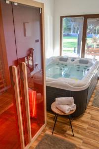 a large bath tub in a room with a chair at Chalet Makov Hrib by Interhome in Tršće