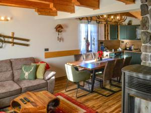 a living room with a couch and a table at Chalet Makov Hrib by Interhome in Tršće