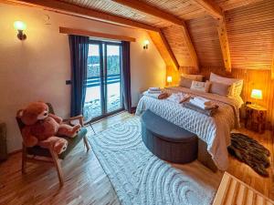 a bedroom with a large bed and a teddy bear at Chalet Makov Hrib by Interhome in Tršće