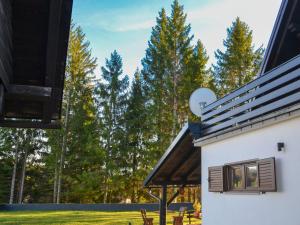 a house with a window and trees in the background at Chalet Makov Hrib by Interhome in Tršće +19 photos