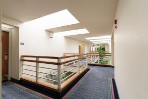 a hallway with a staircase in a building at The Monarch Resort in Pacific Grove