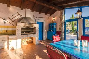 a dining room with a stone fireplace and a table at Old Stonehouse Stari San in Pinezici