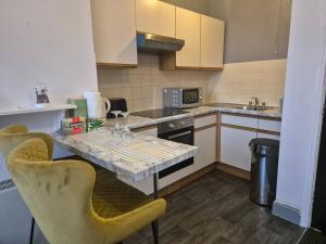 a small kitchen with a table and chairs in it at Glams one bedroom apartment in Wolverhampton