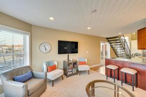 a living room with a couch and a tv at 'Phoenix Nest' South Haven Condo: River View! in South Haven
