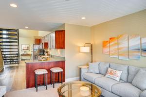 a living room with a couch and a kitchen at 'Phoenix Nest' South Haven Condo: River View! in South Haven